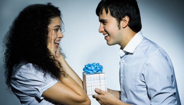 Young Man Giving Young Woman a Present --- Image by © Rob Chatterson/Corbis