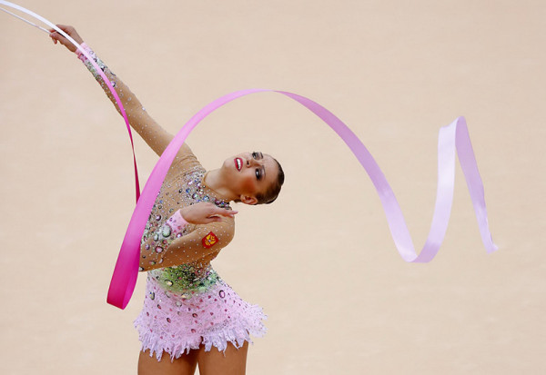 Russia's Evgeniya Kanaeva competes using the ribbon in her individual all-around gymnastics final match to win gold at the Wembley Arena during the London 2012 Olympic Games