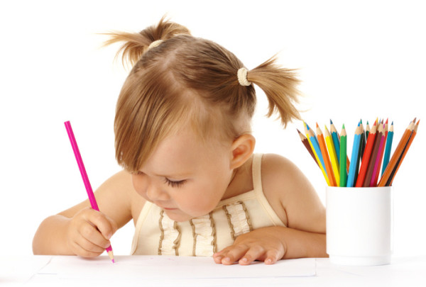 Cute child draw with pencils, isolated over white