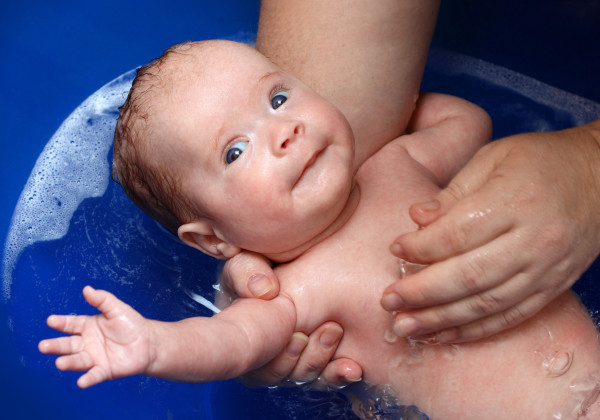 newborn baby bath in blue bathtub