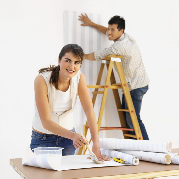 Young couple handing wallpaper