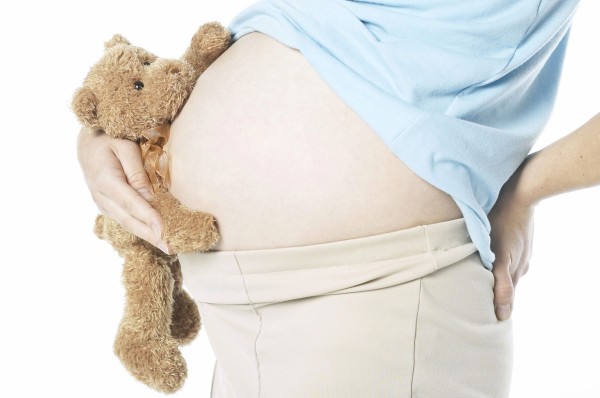 02A10V2T; Pregnant woman holding teddy bear uid 1285065
