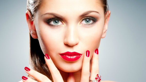 Beautiful girl with bright red manicure