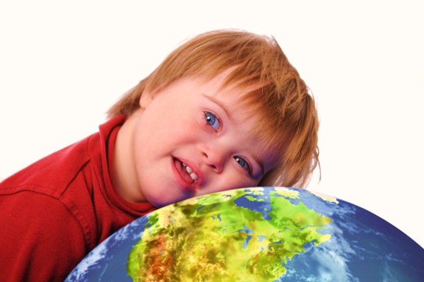 Boy with down syndrome and earth isolated on white