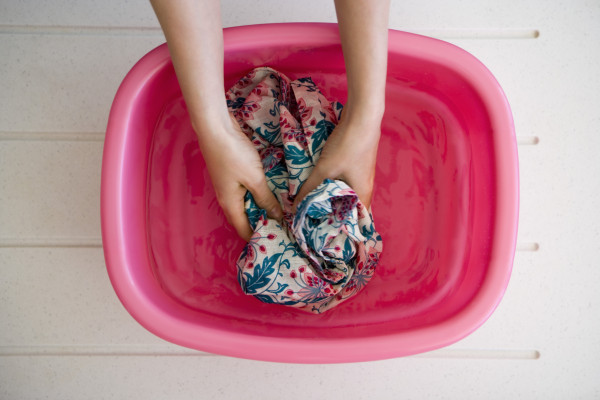 Hands washing laundry