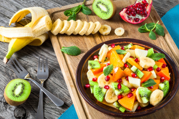 fruit salad in a clay brown dish, close-up, top view