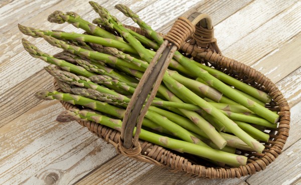 green asparagus in wicker basket