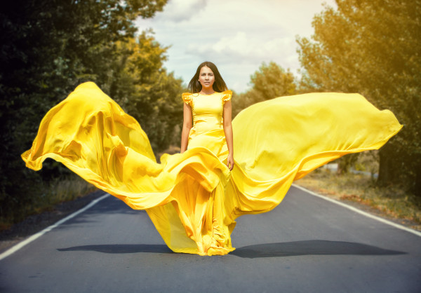 girl in a yellow dress on road